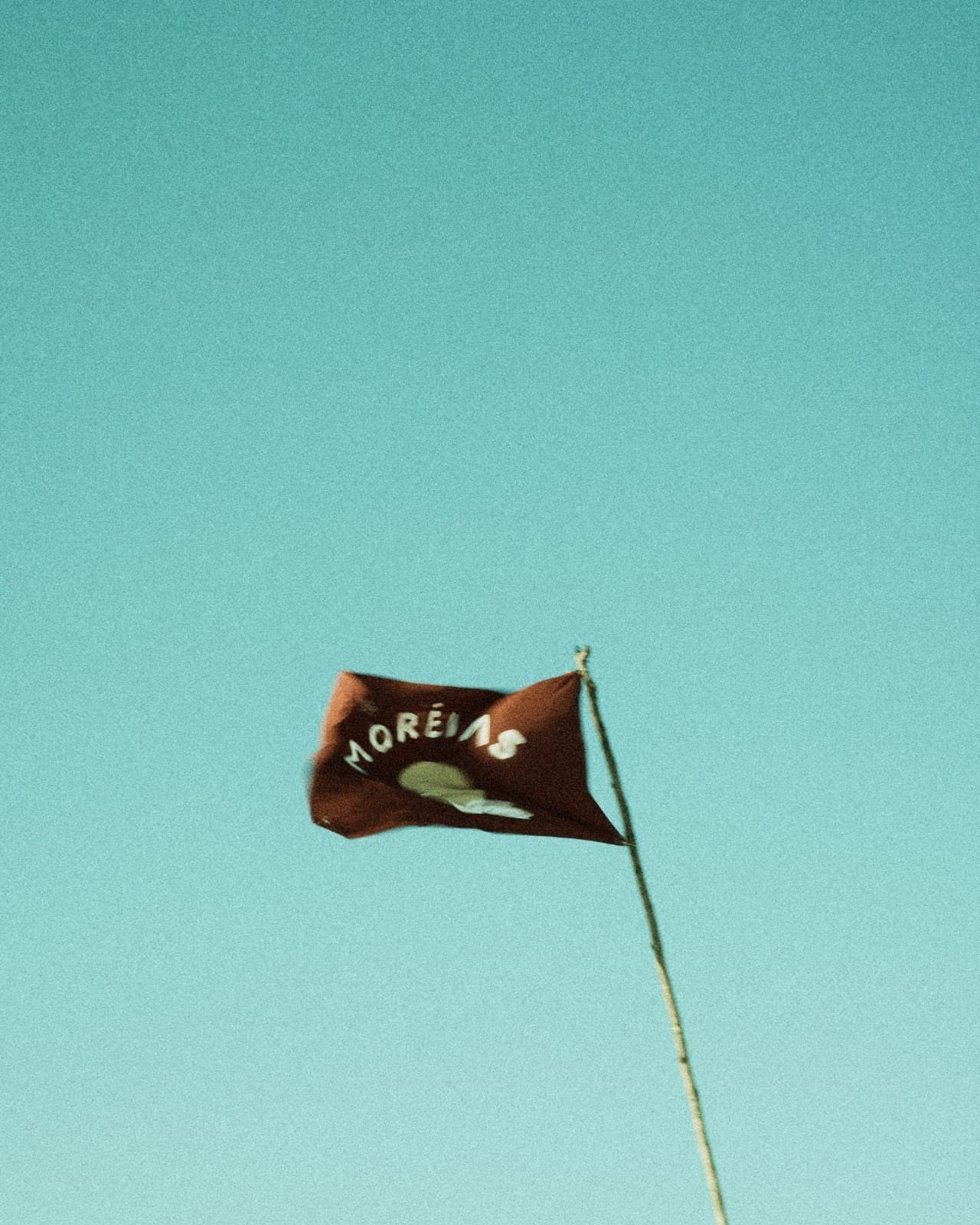 A bandeira Moréias ao vento, contra o céu