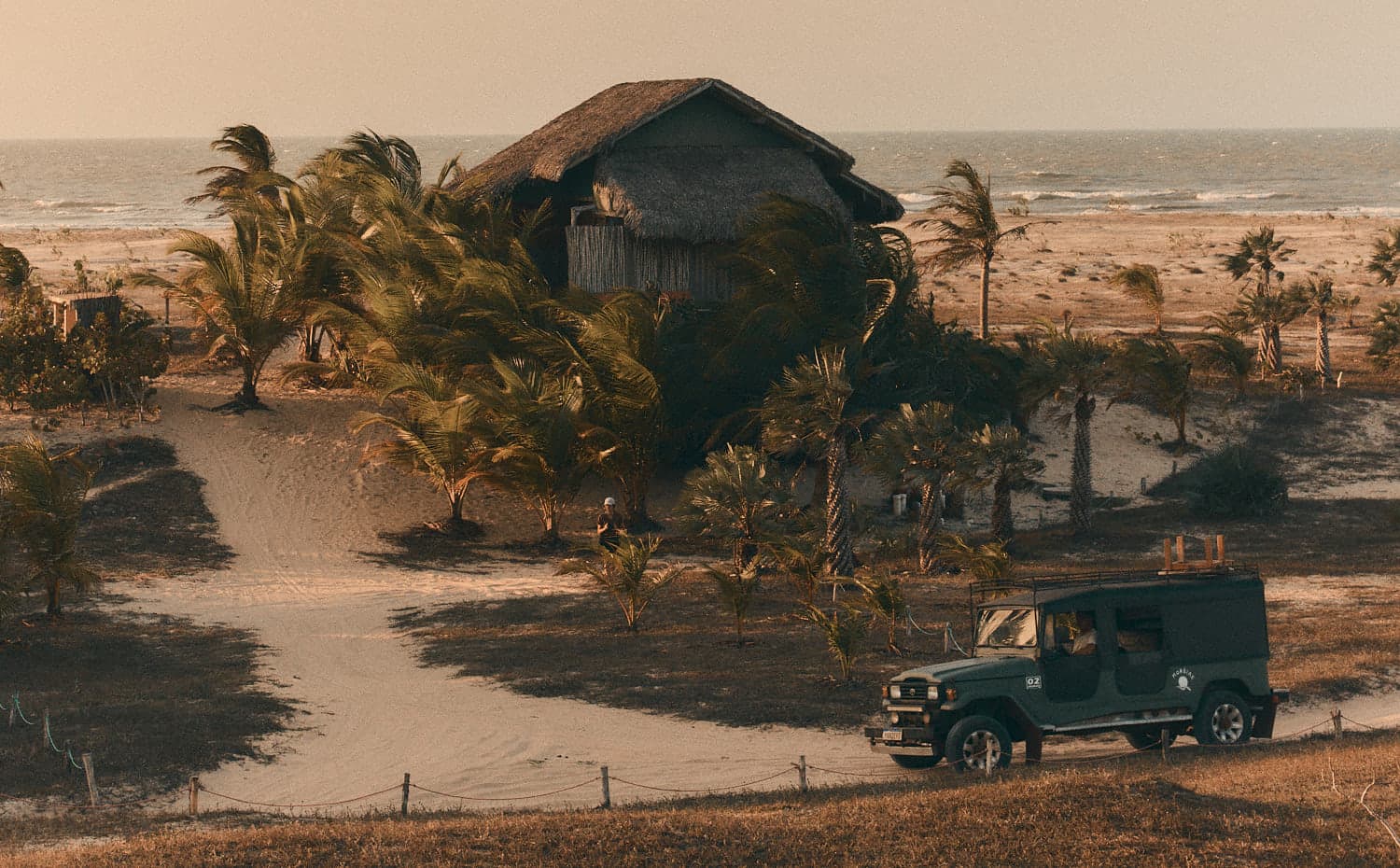 The Moréias jeep on the sand track, with the sea in the background